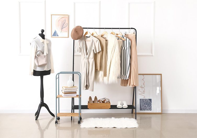 Beige and white clothing on a nicely styled rack